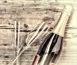 Champagne. Champagne bottle and two empty glasses on a wooden background. Valentine's Day. Birthday. Wedding. Anniversary. Rustic style.