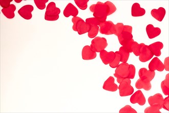 scattered red hearts on a white background. Excellent background to the day of Saint Valentine.
