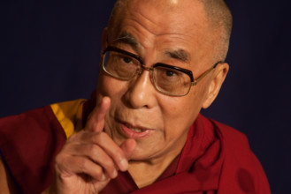 Dalai Lama Tenzin Gyatso, speaking at a function.